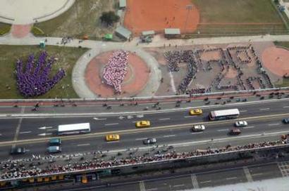 Supporters of Taiwan President Chen Shui-bian form with umbrellas symbols that represent 'Hand in Hand with Taiwan on 228' (a reference to the date) at a Taipei park on February 28, 2004, as part of a massive human chain to protest against Chinese missiles aimed at Taiwan. Chen Shui-bian and more than one million of his supporters formed a human chain down the length of the island on Saturday in its biggest ever protest against China. The day-long demonstration to oppose China's deployment of nearly 500 missiles aimed at Taiwan is seen as Chen's best chance rallying support for his re-election in a March 20 vote. REUTERS/Pool 